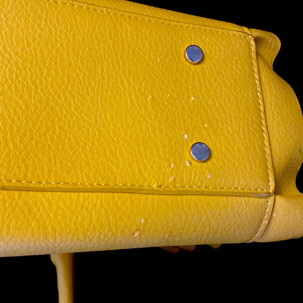 YELLOW EVA MENDES NEW YORK & COMPANY HANDBAG. It has 2 dividers with zippers.